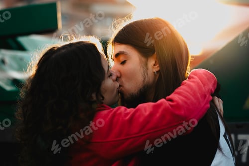 Preview: Long haired man hugging and kissing woman near train