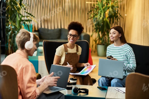 Preview: Colleagues collaborate at a vibrant hotel lounge during a business trip