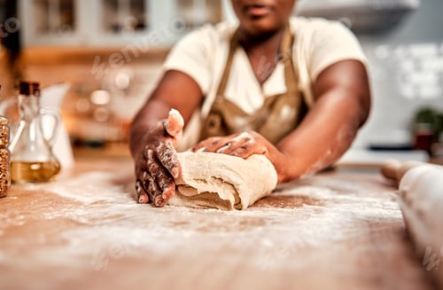 Preview: Culinary hobby. Close up of plump female hands in flour skillfully kneading dough for homemade pastr