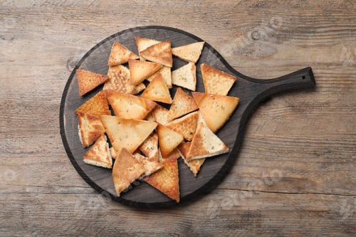 Preview: Delicious pita chips on wooden table, top view