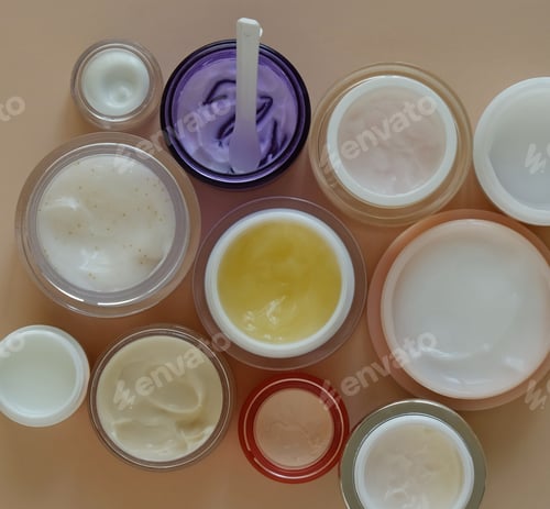 Preview: Many jars of beauty cream or mask for face care on pastel background, top view.