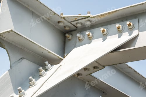 Preview: Bolts and nuts on metal plates of steel structure of heavy duty straight crossbar of frame