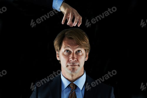 Preview: Ever have an impending sense of doom. Concept shot of a businessman with a hand hovering above him.