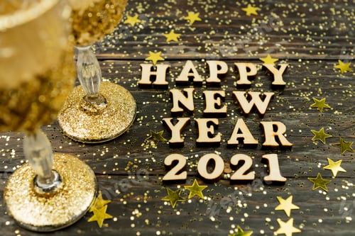 Preview: Happy New year 2021 celebration.Champagne glasses and and text happy new year 2021 on wooden