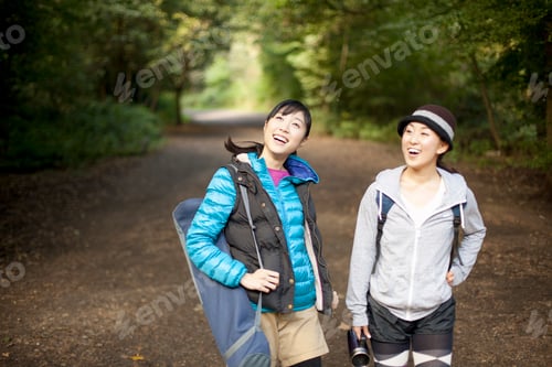 Preview: Two young female hikers on country road