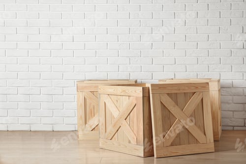 Preview: Wooden crates on floor near brick wall, space for text