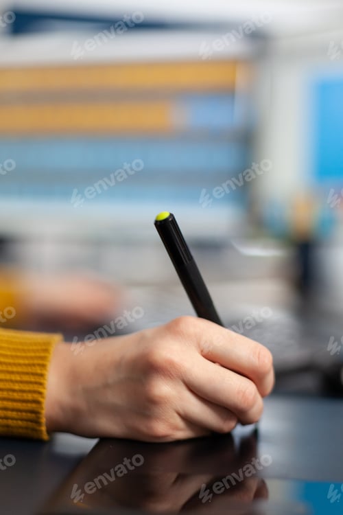 Preview: Close up on hand of african photo editor drawing on graphic tablet