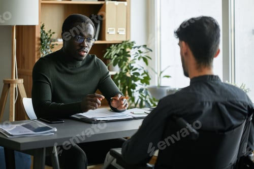 Preview: Manager and his co-worker with disability working together on business strategy