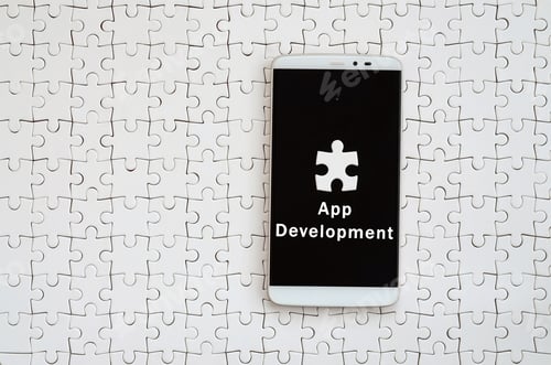 Preview: A modern big smartphone with a touch screen lies on a white jigsaw puzzle