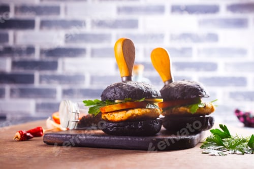 Preview: Tasty craft burger with black bun on the board