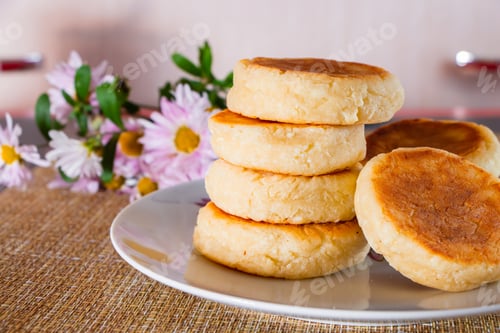 Preview: Homemade food - cottage cheese pancakes with sour cream and jam on a brown background.