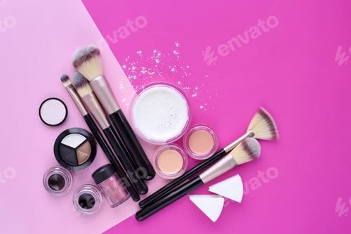 Preview: Makeup brush and decorative cosmetics on pink background. Top vi