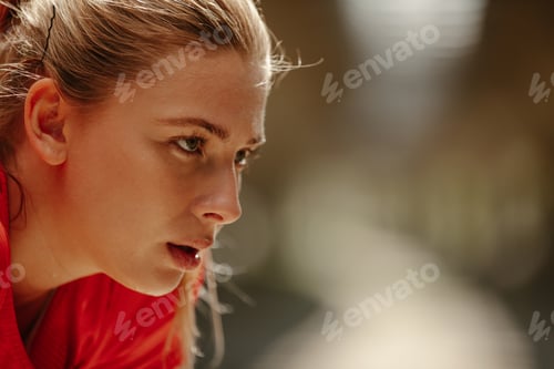 Preview: Close up photo of athletic blonde woman sweating taking a break from workout.