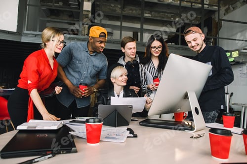 Preview: Group of young six business people and software developers in casual outfit working as a team in