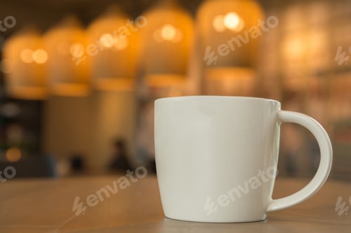 Preview: white coffee mug on the wooden table in the coffee shop with cozy atmosphere