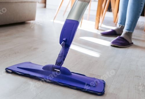 Preview: Close-up cropped image of person using mop for cleaning floor in apartment