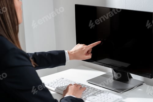 Preview: Businesswoman Pointing Important Infortmation With One Finger On Computer.