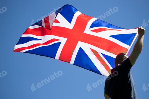 Preview: Patriot man holding the United Kingdom flag.