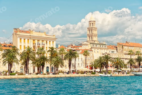 Preview: Palm trees line the waterfront promenade in front of historic buildings and St Domnius