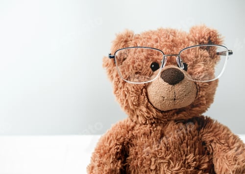 Preview: toy teddy bear in eyeglasses. study or eyesight concept.