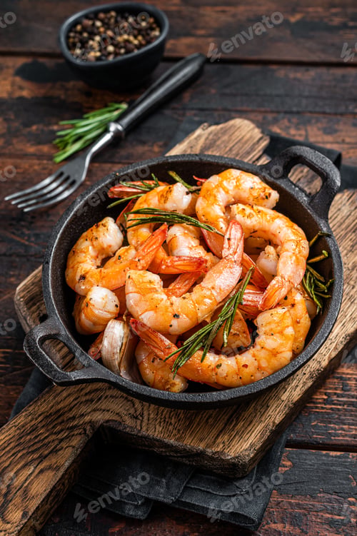 Preview: Roast Prawns Shrimps in a pan with herbs and garlic. Dark wooden background. Top view