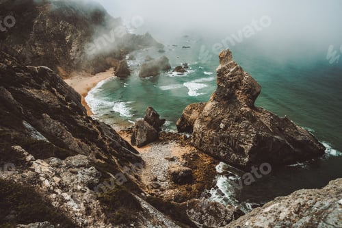 Preview: Sentra, Portugal. Moody foggy weather at Praia da Ursa beach on morning. Rough Atlantic Ocean