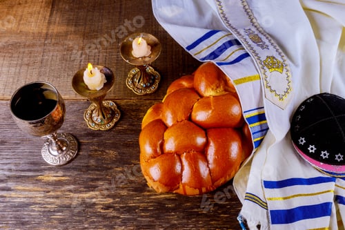 Preview: Shabbat challah bread, shabbat wine and candles on the table.