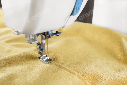 Preview: Modern Sewing Machine With Yellow Velours Fabric Close Up