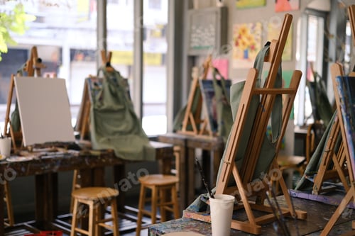 Preview: Interior of the creative art workshop with wooden easels and painting equipment.