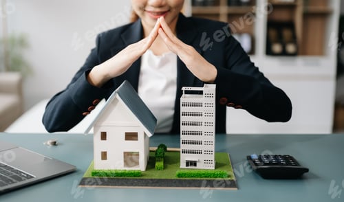Preview: Female real estate agent is use hands to protect red roof for the concept