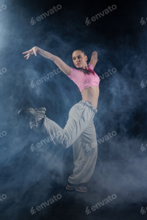 Preview: Urban jazz funk dancer performing high kick in smoky studio