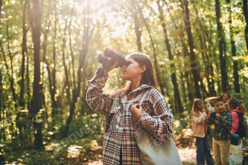 Preview: Discovering new places. Kids in green forest at summer daytime together