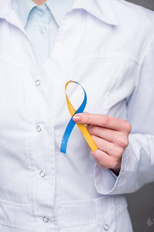 Preview: Close-up view of female doctor holding Down Syndrome Day ribbon