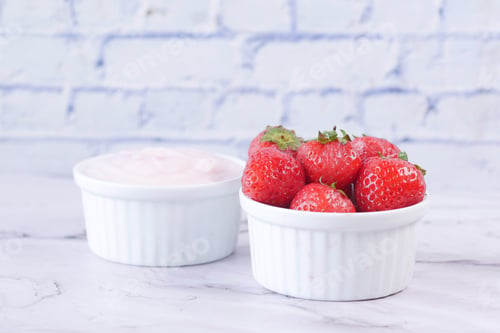 Preview: Yogurt and strawberry in a bowl on white