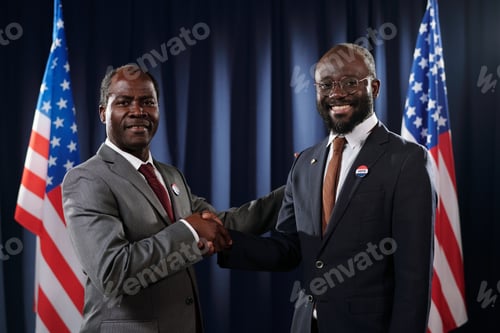 Preview: Two successful political leaders in formalwear shaking hands