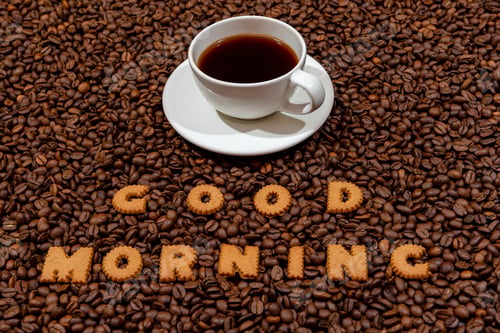 Preview: White caffee mug and words GOOD MORNING made from biscuit letters on a dark coffee bean background,