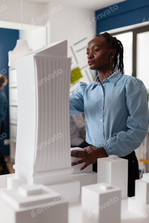Preview: Portrait of architect looking at the architecture design of futuristic building