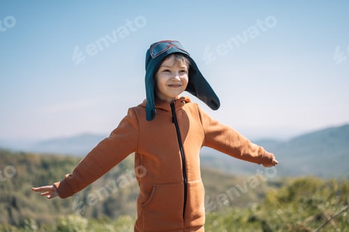 Preview: Boy dressed as pilot stands outdoors