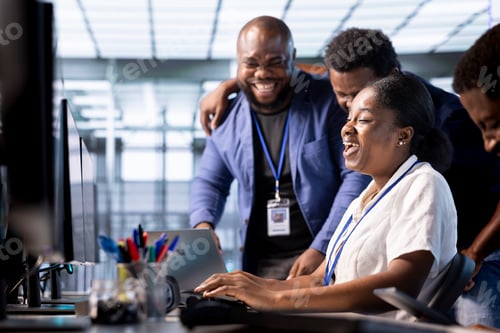 Preview: Team of happy engineers laughing in data center office