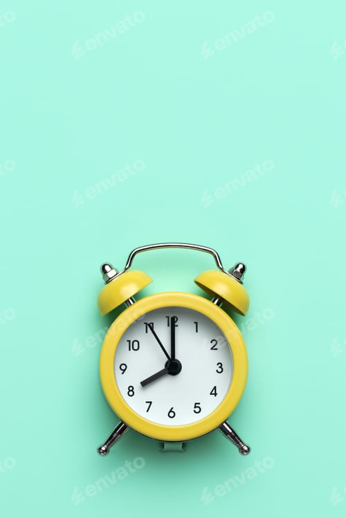 Preview: Yellow round alarm clock on the cyan background.