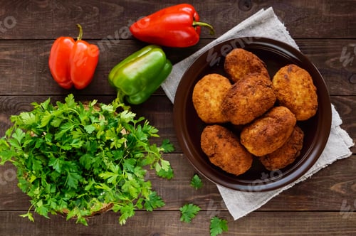 Preview: Meat mini-rolls (cutlet) with boiled egg in a clay bowl on dark wooden background. The top view.