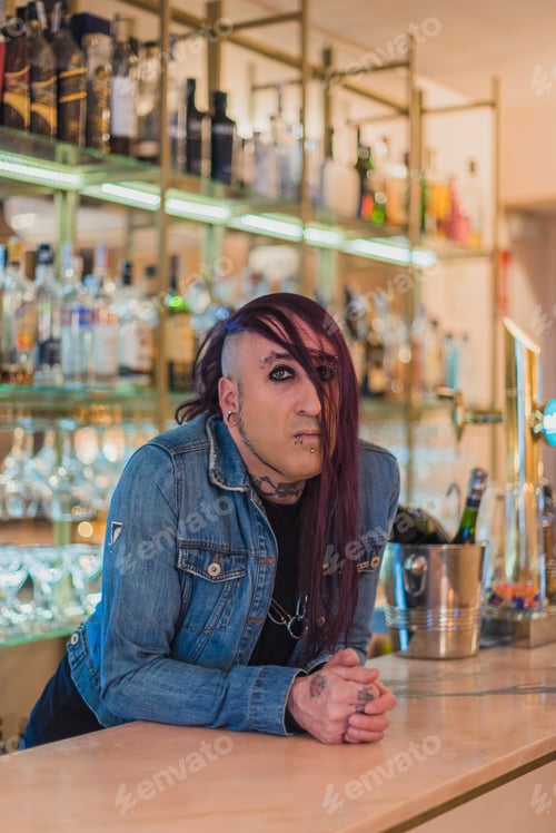 Vista previa: Portrait of an eccentric rocker with a denim jacket. He has long purple hair.