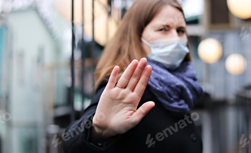 Preview: Young European woman in protective mask on the street.