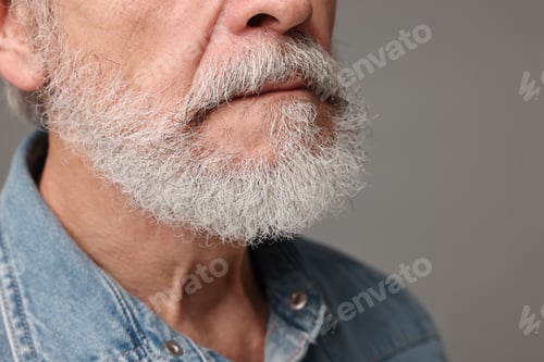 Preview: Man with mustache on grey background, closeup