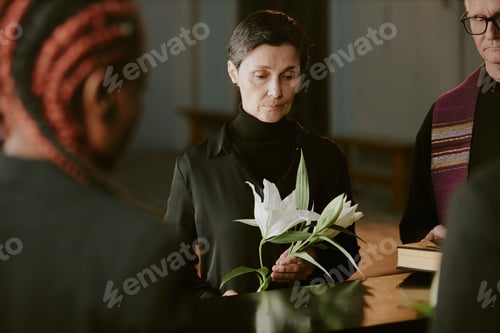 Preview: Senior Woman Preparing to Lay Bouquet