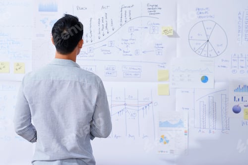 Preview: Pensive entrepreneur looking at chart