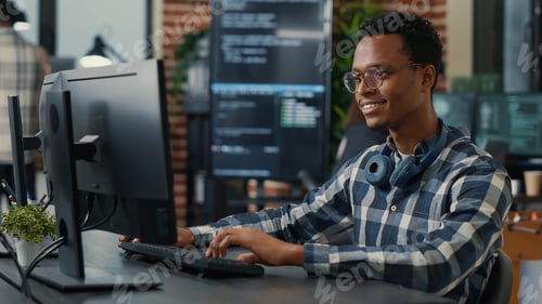 Preview: Portrait of software engineer writing code arranging glasses and being happy about parsing results
