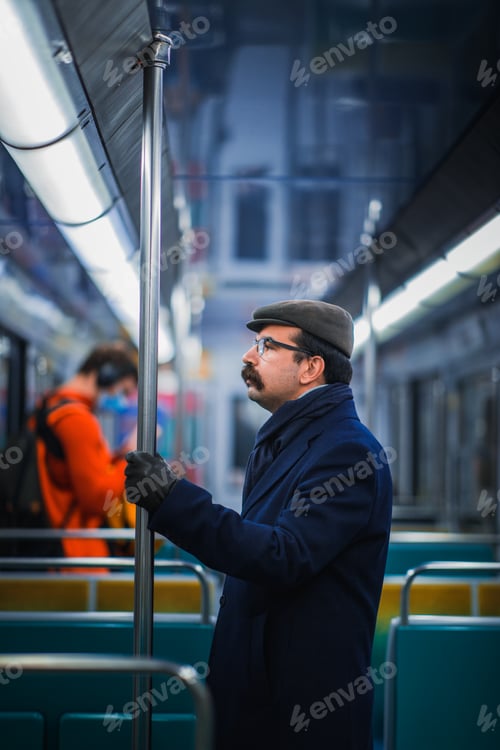 Preview: Paris, France, January 12 2022 A capped Moustached man in a journey with public transport.