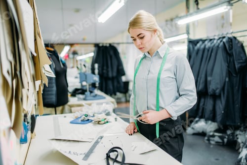 Preview: Clothes designer measures a pattern, sewing