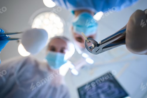 Preview: Surgeon with special forceps and extracted tooth in his hands